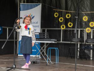 This is a photo of a girl singing up on stage at the event
